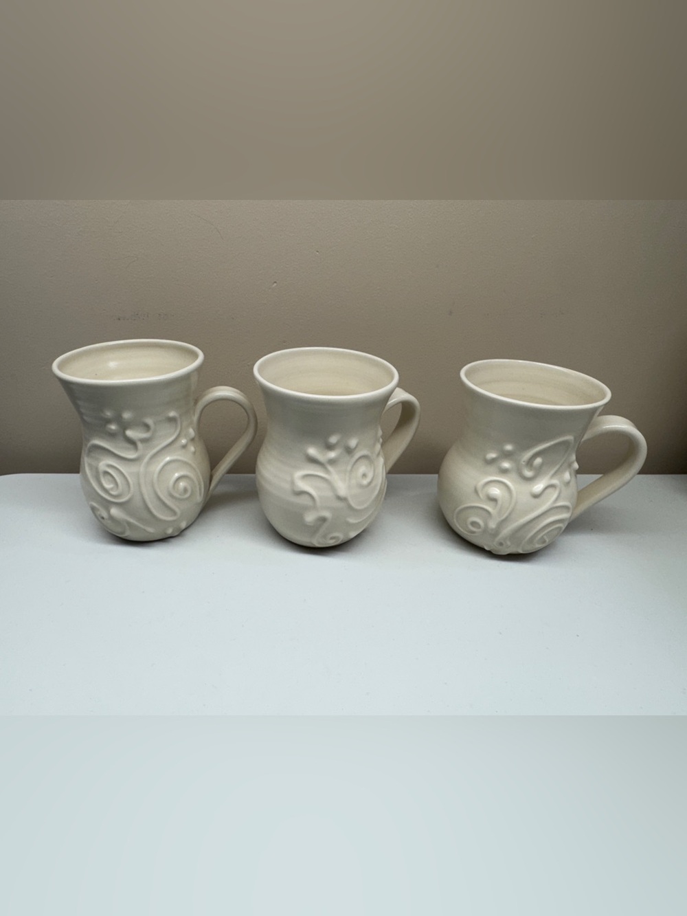 Cream Clay Pottery Embossed Swirl Mugs - signed Set of 3